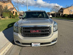 Front view of a 2015 GMC Yukon SLT RWD in excellent condition with alloy wheels and clean title.