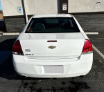 2012 Chevrolet Impala in great condition, parked outside, showing rear view. Excellent mileage and features.