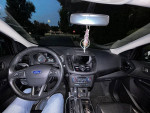 Interior view of a 2018 Ford Escape Titanium showcasing the steering wheel and dashboard features.