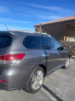 Side view of a 2016 Nissan Pathfinder Platinum FWD parked, showing sleek design and alloy wheels.