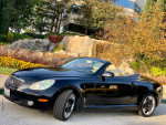2005 Lexus SC430 convertible in pristine condition parked near colorful flowers
