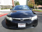 Front view of a black 2008 Honda Civic LX with 123,000 miles, parked in a residential area.