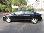 2008 Honda Civic LX in black color, well-kept with 98k miles, parked in a residential area.