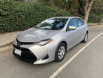2017 Toyota Corolla L FWD silver car in excellent condition with new tires parked on the street.