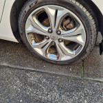Close-up of a custom rim on a 2013 Hyundai Elantra GT, showcasing the stylish design and tire details.