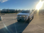 2017 Ford F350 Powerstroke 4x4 Lariat with black leather interior parked in a sunny lot.