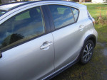 2019 Toyota Prius C hybrid car side view in excellent condition, 118,000 miles on the odometer.