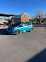 2013 Honda Fit Sport in a parking lot, showcasing its compact hatchback design and clean condition.