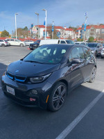 2014 BMW i3 with Range Extender parked in a lot, featuring Terra package and 20-inch rims