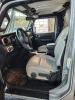 Interior view of a 2019 Jeep Wrangler Sport 4WD with leather seats and modern features